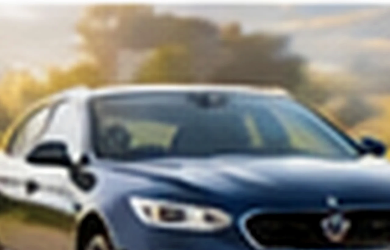 Senior Canadian man receiving keys to a leased electric car from a dealership advisor